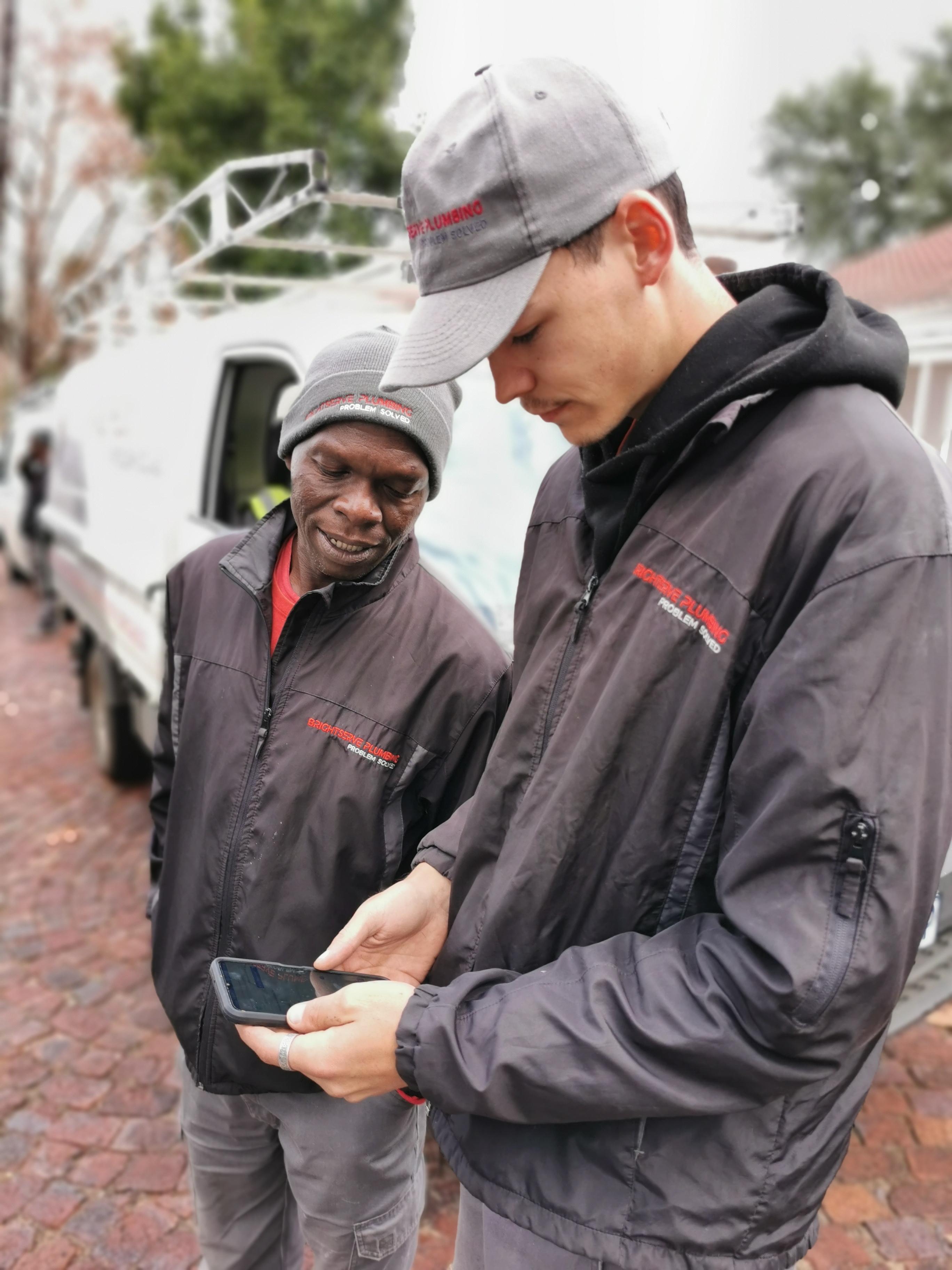 Technician using ServCraft app next to truck